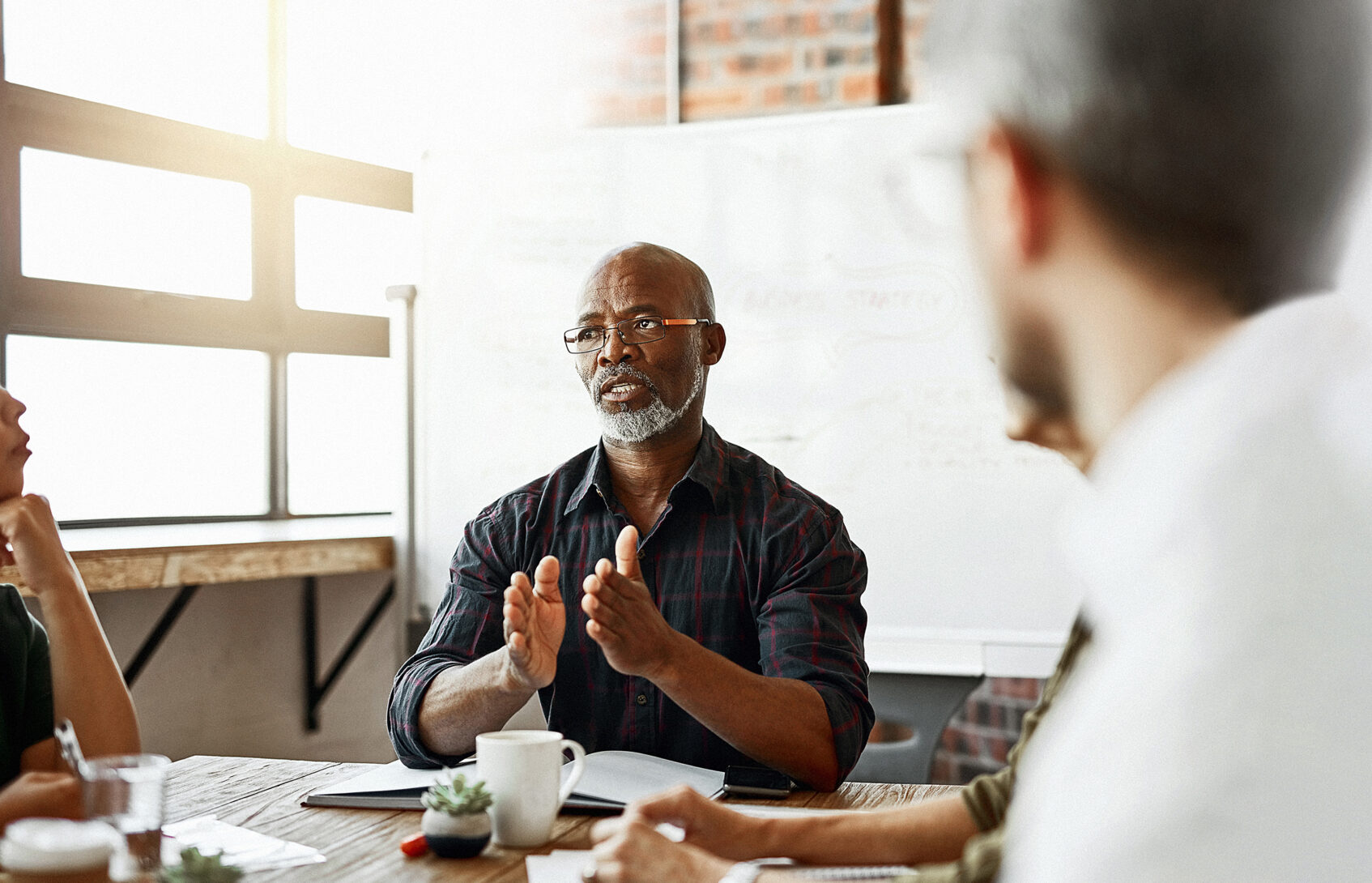 A man addressing a team of people in a meeting