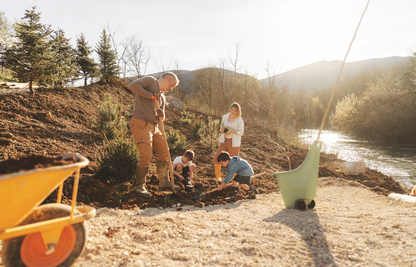 A family planting trees together.