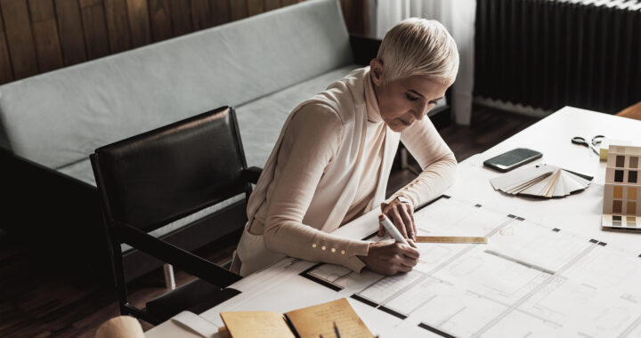 Businesswoman drawing plans in home studio.