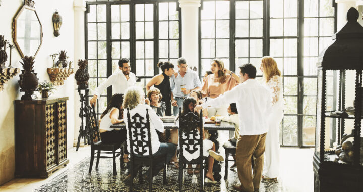 Multigenerational family gathered around dining table.